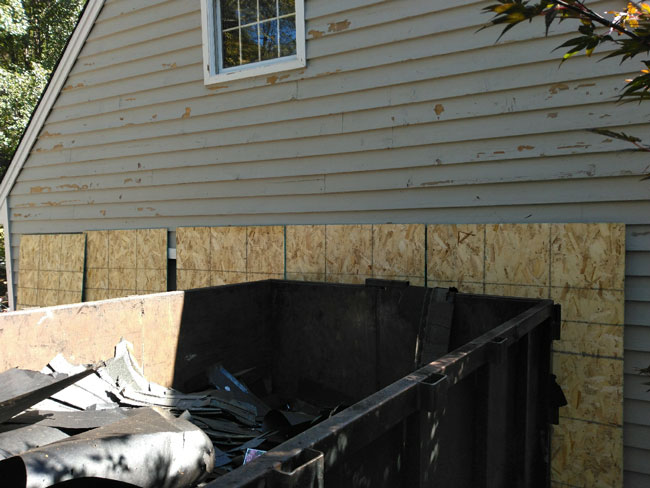 side of old house with dumpster